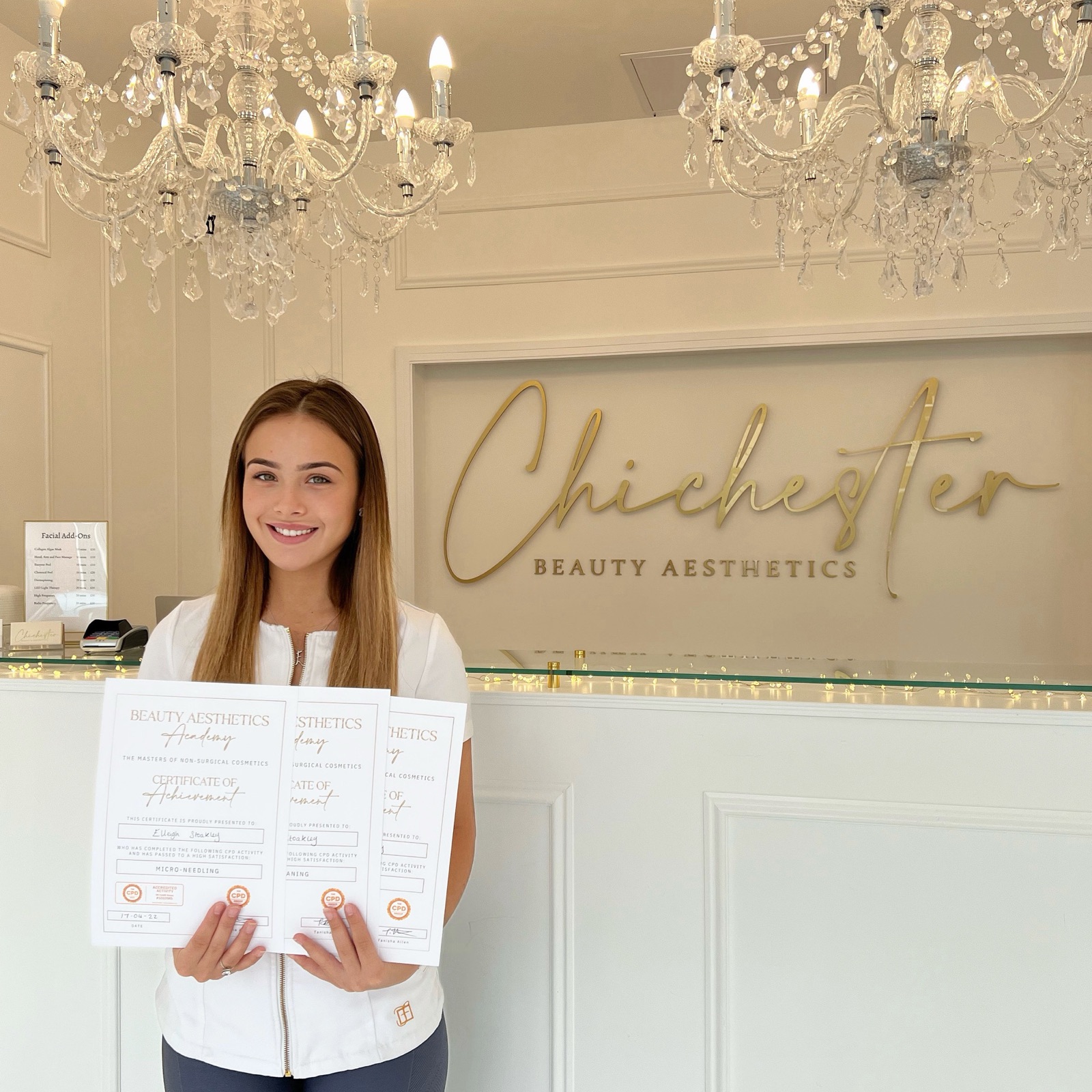 An Academy student holding her certificates at Chichester Beauty Aesthetics
