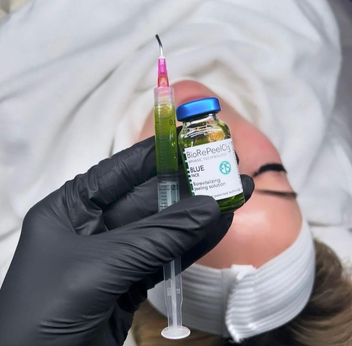 A practitioner preparing a skin peel treatment